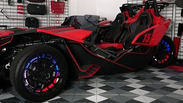 Explore SlingMods product videos: a red Polaris Slingshot in the studio